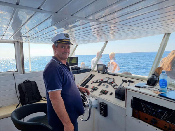 Captain at the helm of the KIT-KAT Dolphin Excursions boat from Novalja