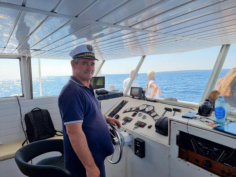 Captain aboard the KIT-KAT boat during our Dolphin Excursions trip from Novalja