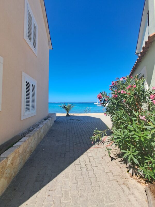 Quiet lane in Olib village leading toward the turquoise Adriatic Sea