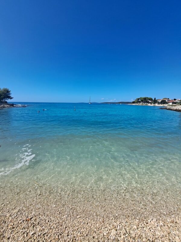 Clear shallow water and turquoise sea at a beach on Silba Croatia