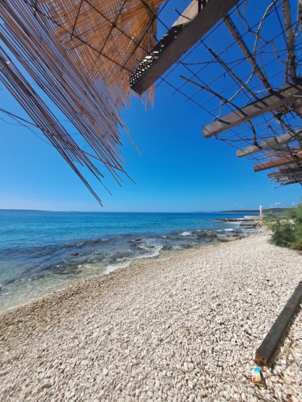 Quiet pebble beach and clear blue Adriatic water on Silba Island