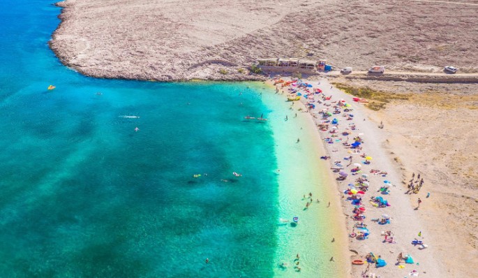 Ručica Beach near Metajna on Pag Island surrounded by dramatic limestone hills and turquoise Adriatic Sea