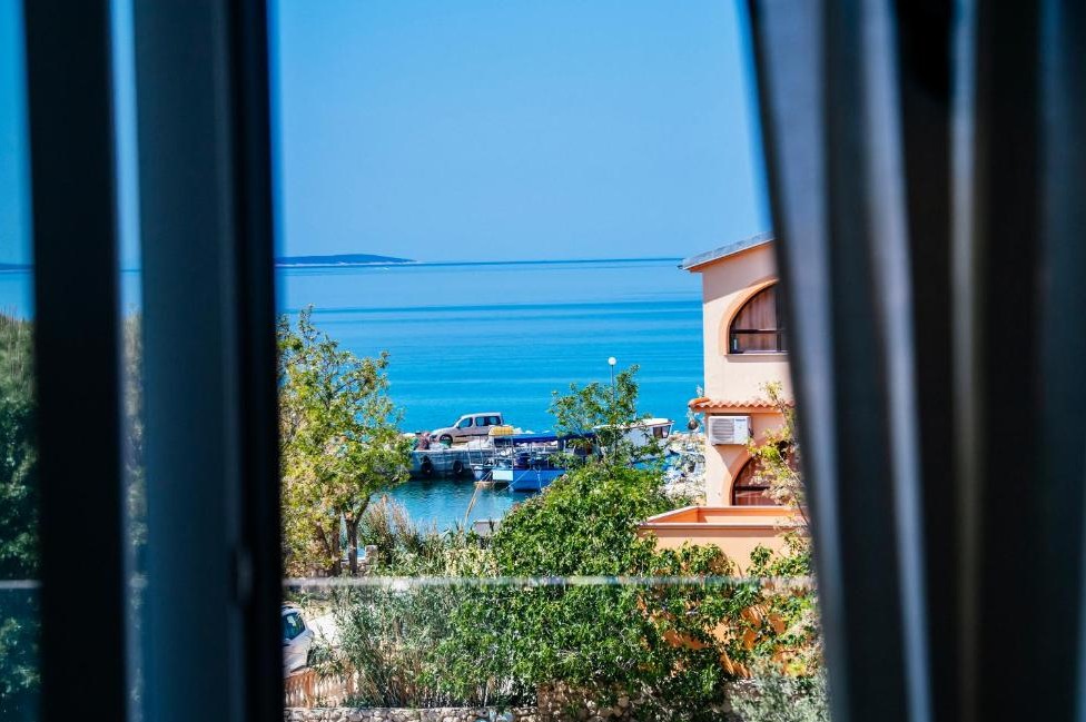 Adriatic Sea and small harbour viewed from a holiday apartment in Proboj on Pag Island, Croatia